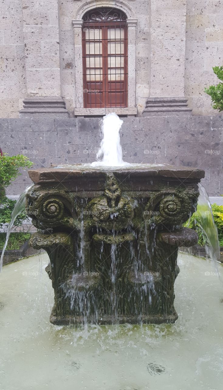 a small fountain in Guadalajara next to the theater