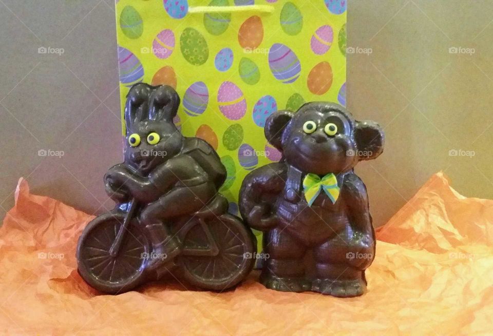 Easter chocolates; a bunny on a bicycle and a monkey with overalls