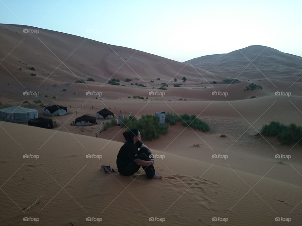 Young woman sitting in desert