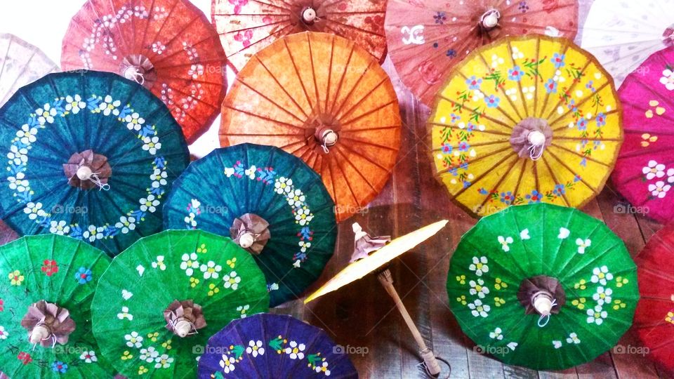 Colourful traditional umbrellas made in craft workshop in floating village on Myanmar's Inle Lake