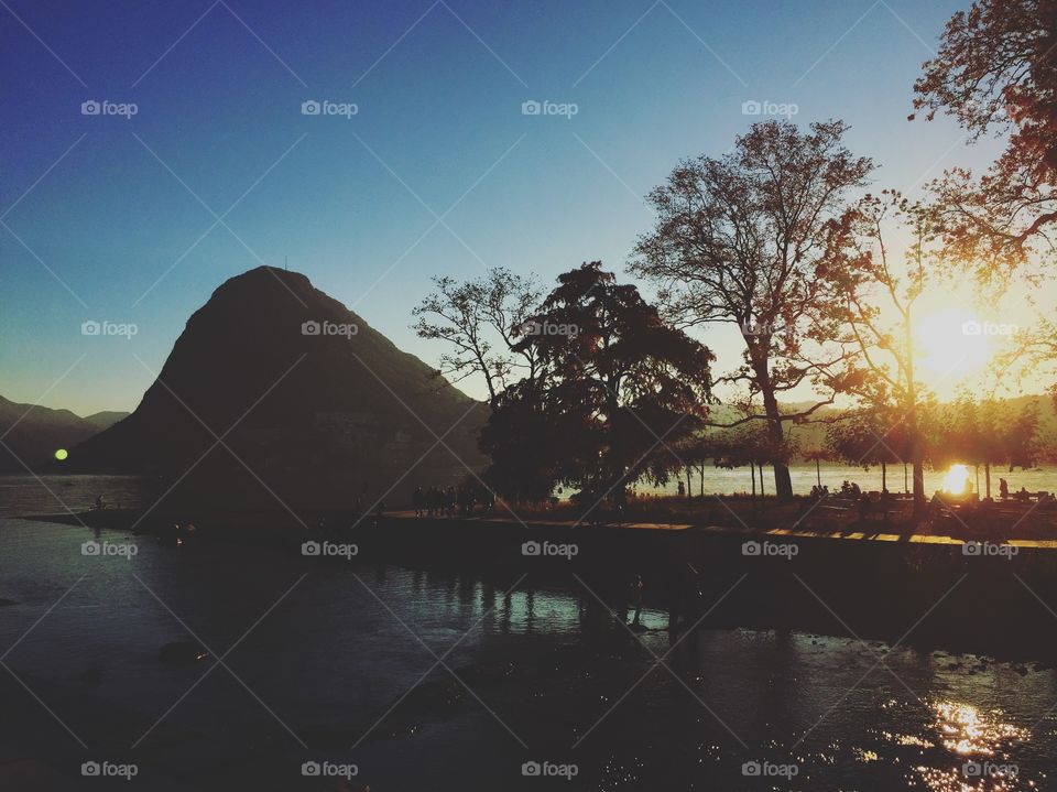 Sunset over Lugano lake in October 