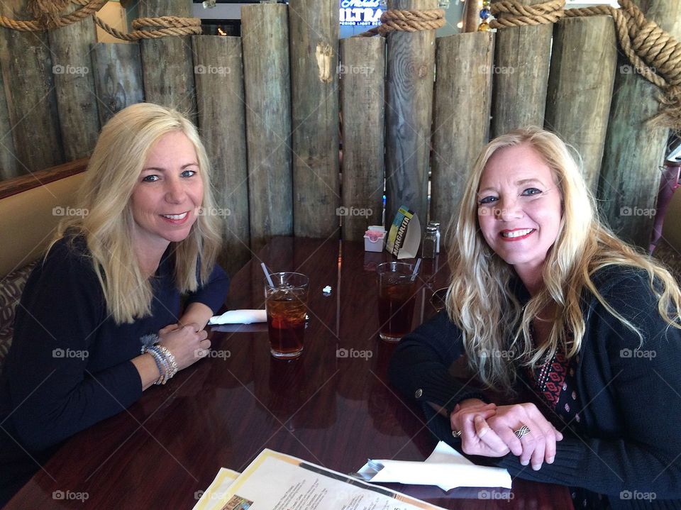 Two smiling woman in restaurant