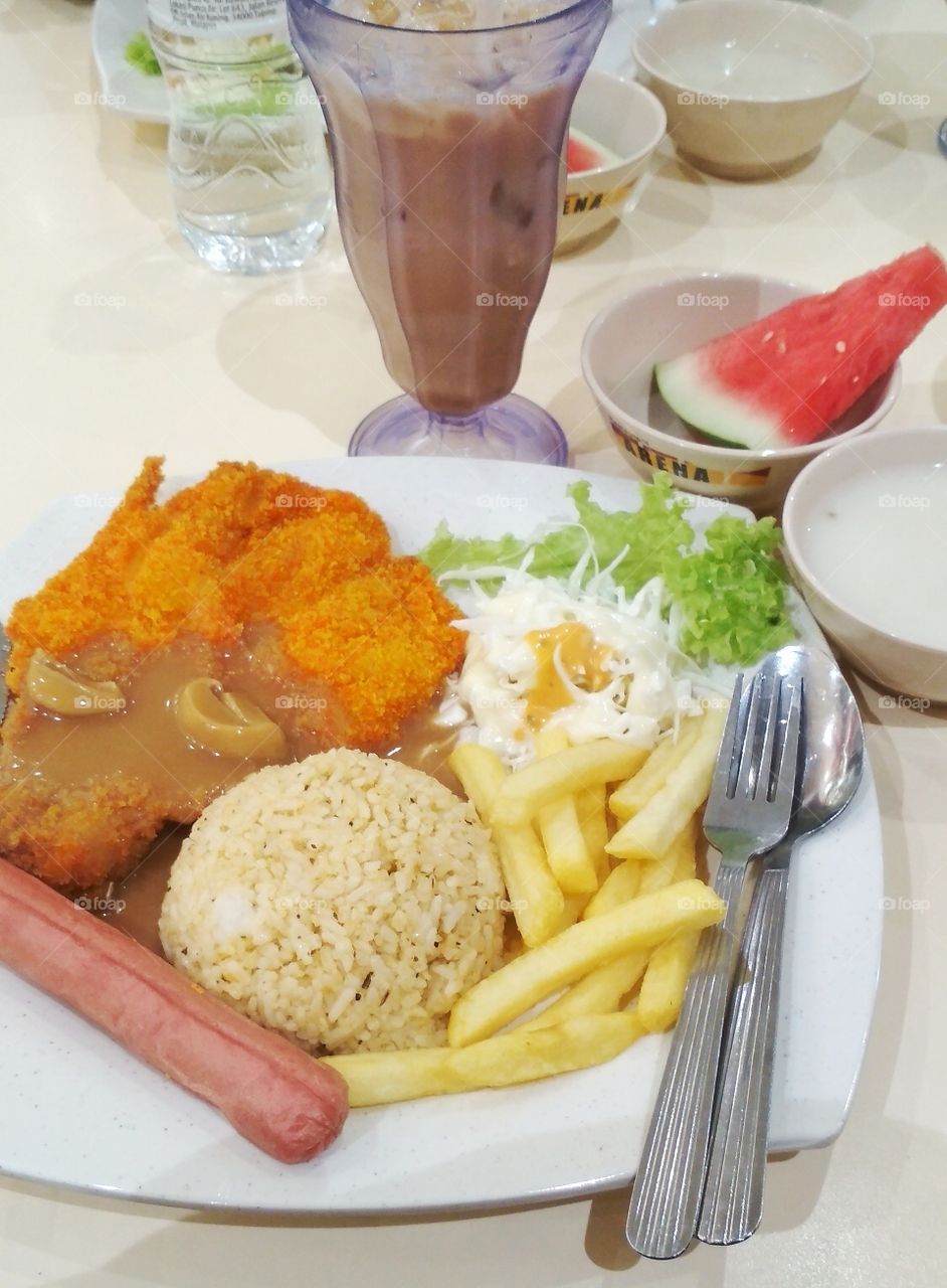 A dinner in a foodcourt. Fried rice with chicken chop!