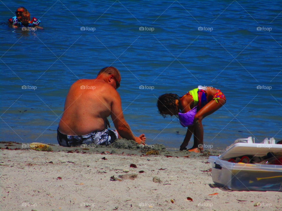 Grandpa and granddaughter at the beach 
