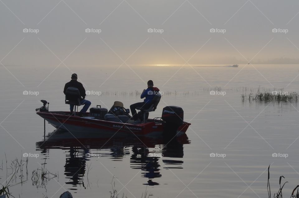 The fishermen are already waiting for the fish early in the morning. There's a promise of morning in the distance, a thin sliver of gold started appearing on the edge of the silver lake. What a happy grey story!