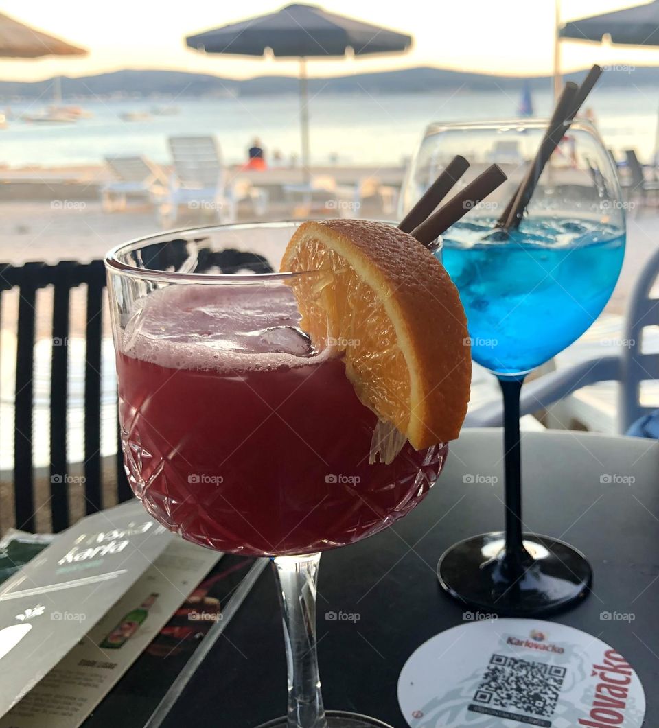 Enjoying fine blue and red cocktails