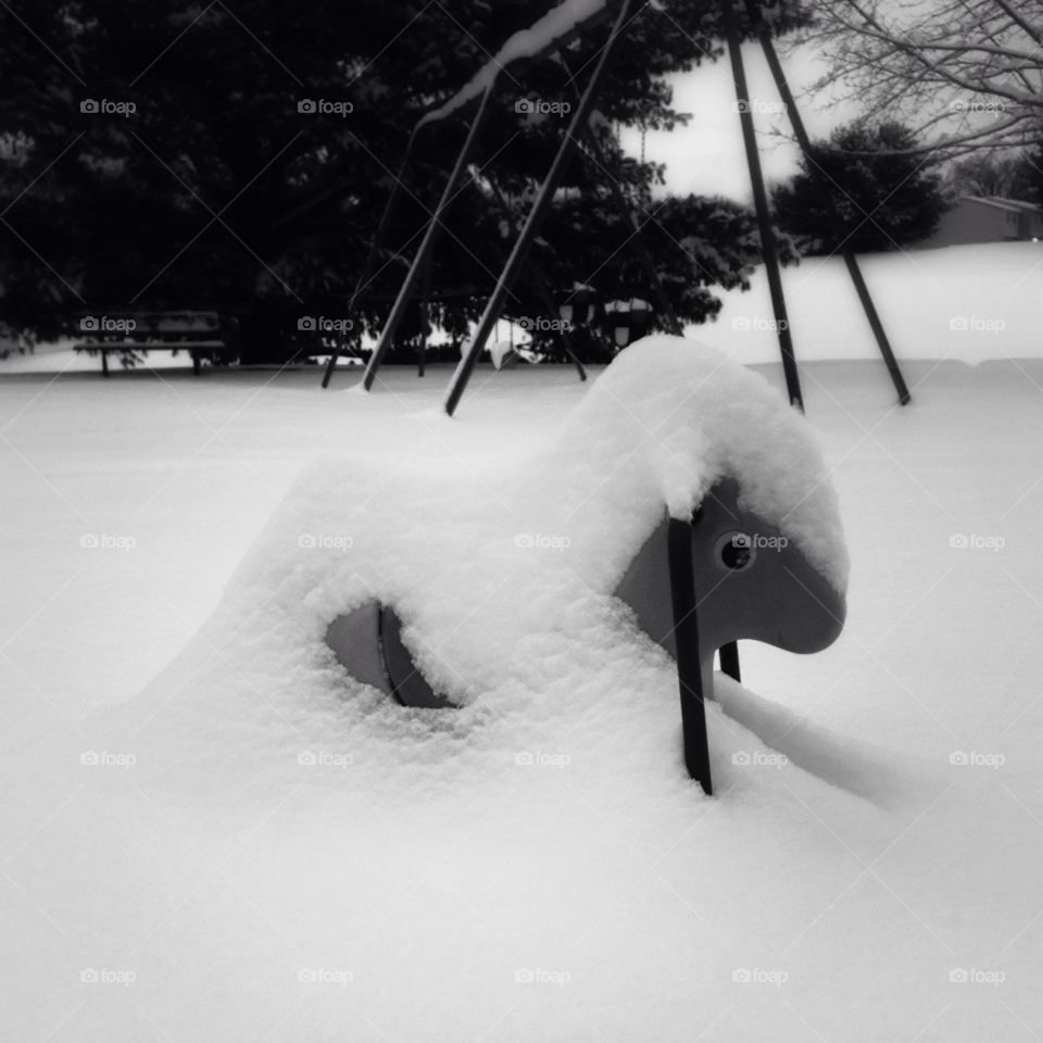 Playground toy or ride under snow in black and white. B&W
