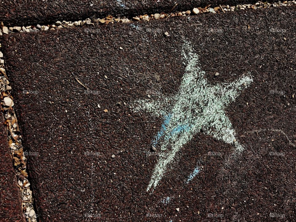 Star in chalk on ground