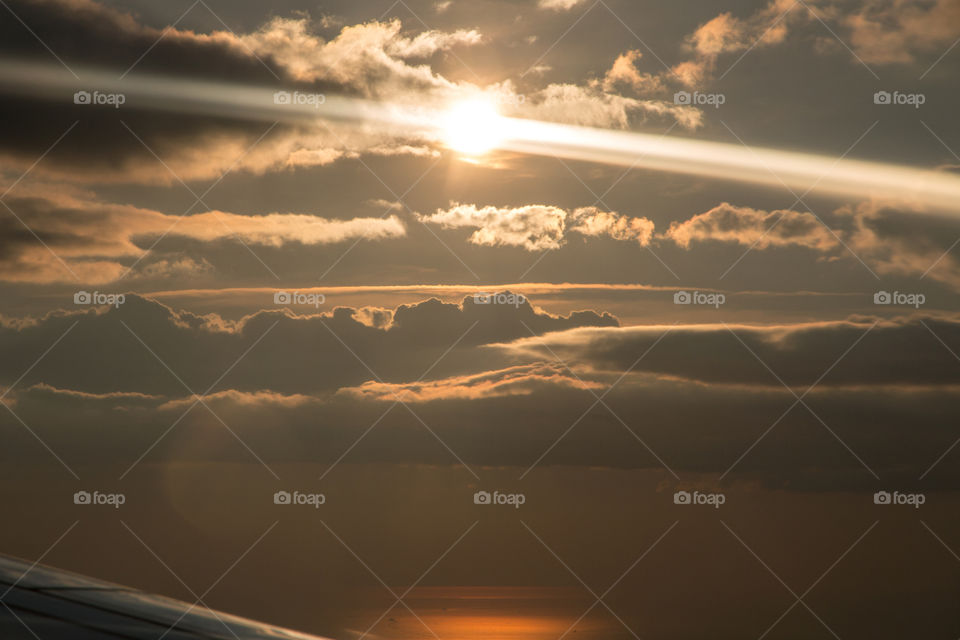 Sunrays over the ocean - view from airplane 