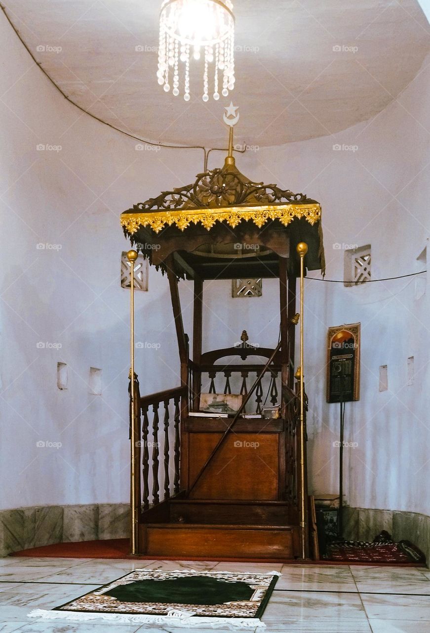 the pulpit where the imam stands to deliver a religious sermon.
