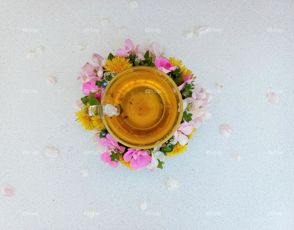 a glass of tea and flowers.