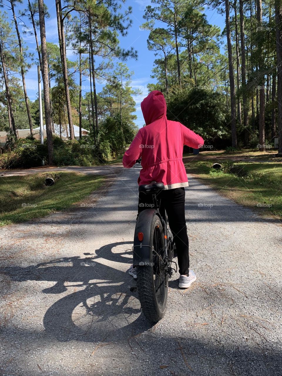 Women riding E-bike - Scooters and Bicycles on city streets. The law allows people to operate bicycles with electric assist (e-bikes) on some streets and highways