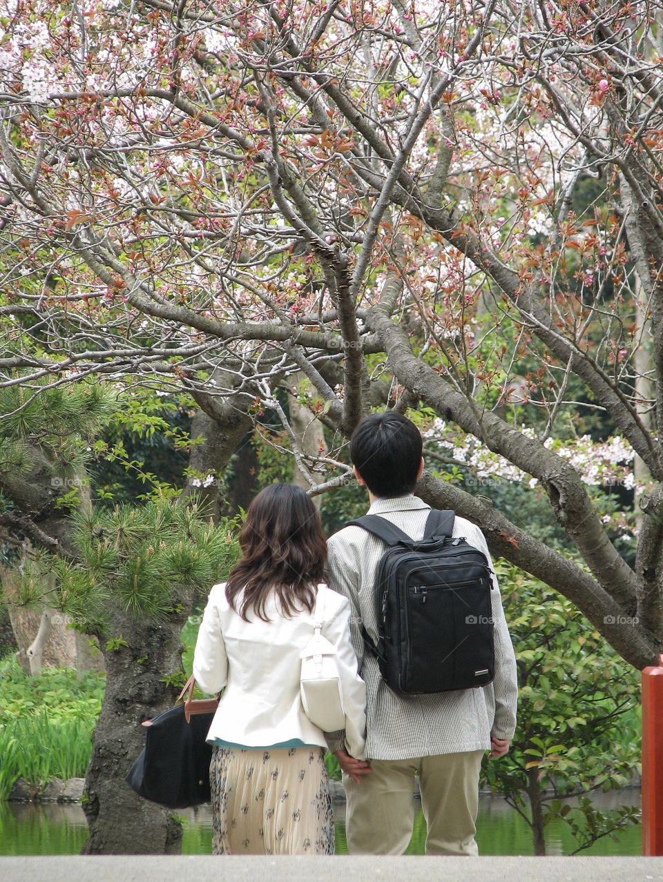 Young lovers take their happiness time to see the beautiful flower