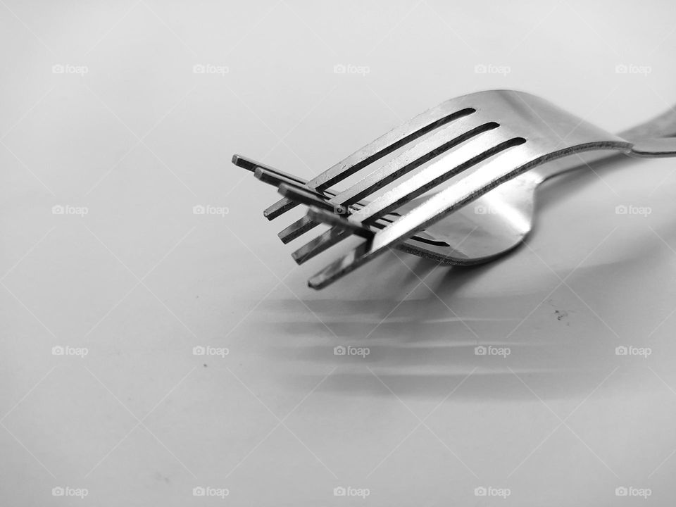 Two forks joined together, isolated on white background