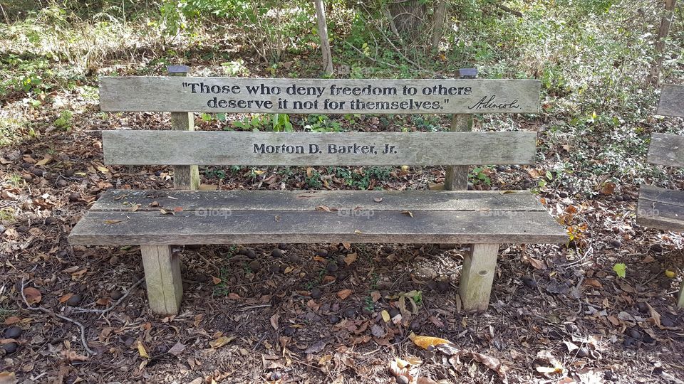 an aging bench with an inscription of one of Lincoln's famous quotes, at the Abraham Lincoln Memorial Gardens