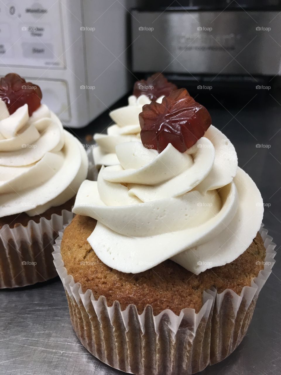 Maple sapping brings spice cake cupcakes with maple frosting and a maple candy on top!