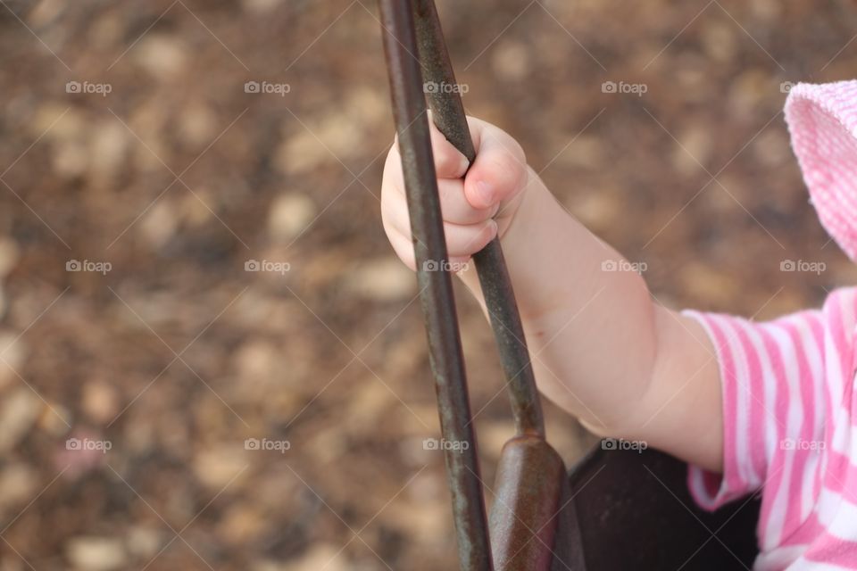 Baby hand on the swing