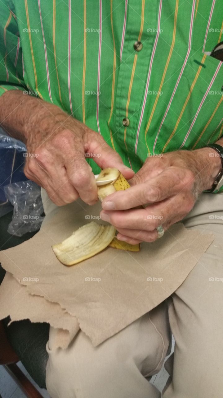 Feeding his wife with Alzheimers her farvorite food.