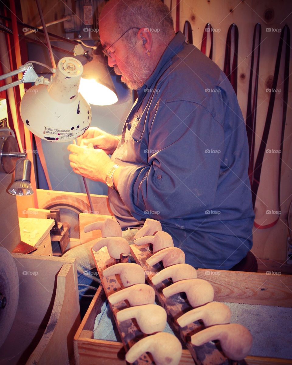 Senior man working on his wooden equipments