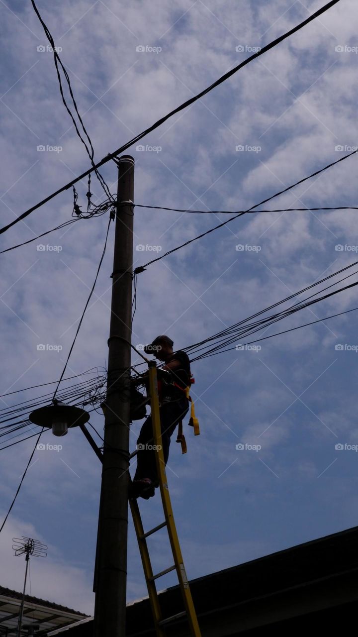 Human interest - A worker is repairing a street light