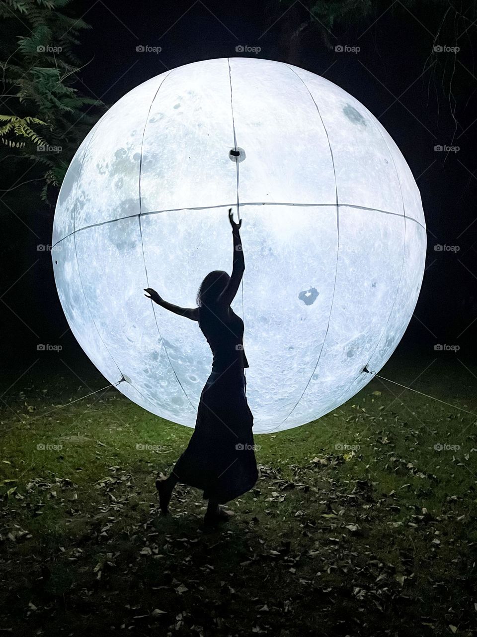 Woman Dancing in Front of the Art Installation Moon