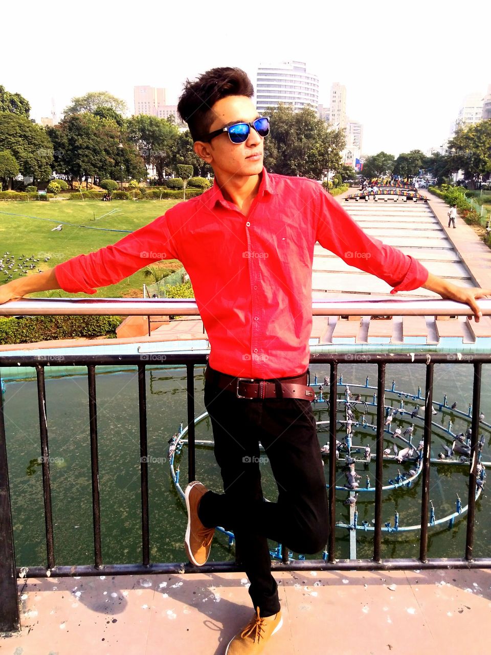 Asian young man leaning on railing