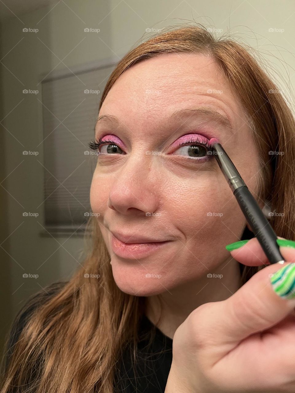 Putting on bright pink magenta eyeshadow 