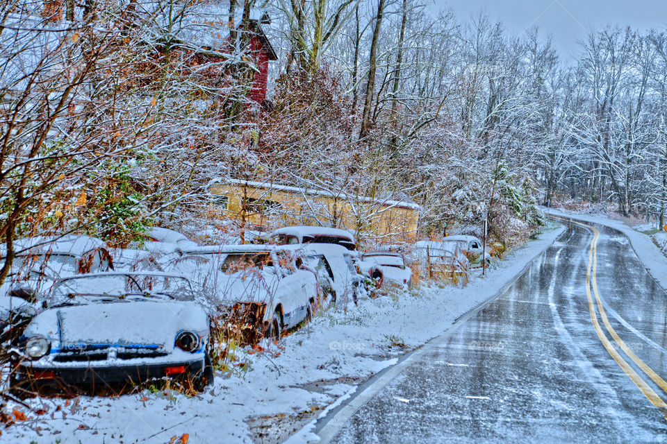 icy junkyard. old cars, trucks & buses coated with ice