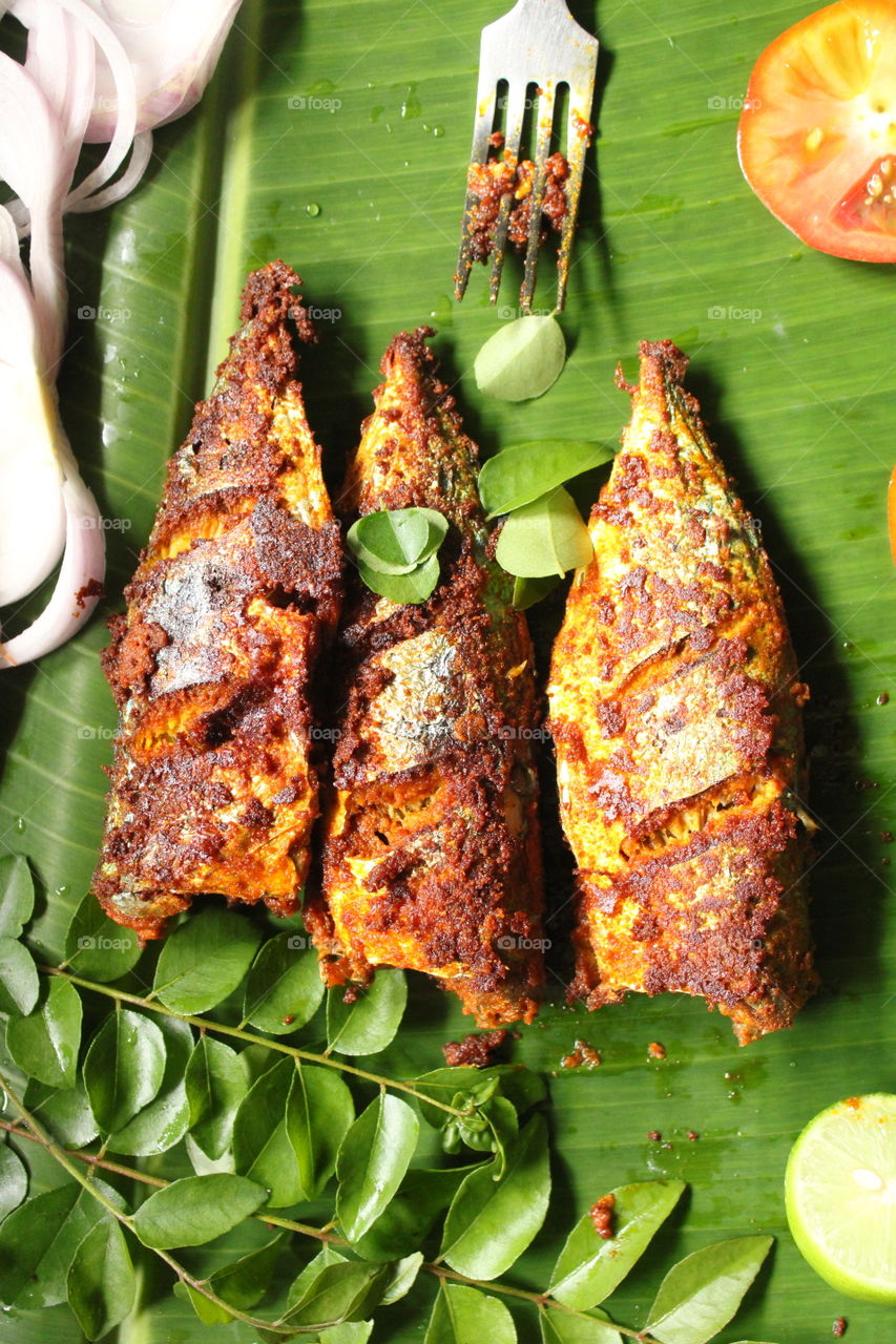 South Indian special fish fry in banana leaf.Homemade fish fry, healthy seafood concept.