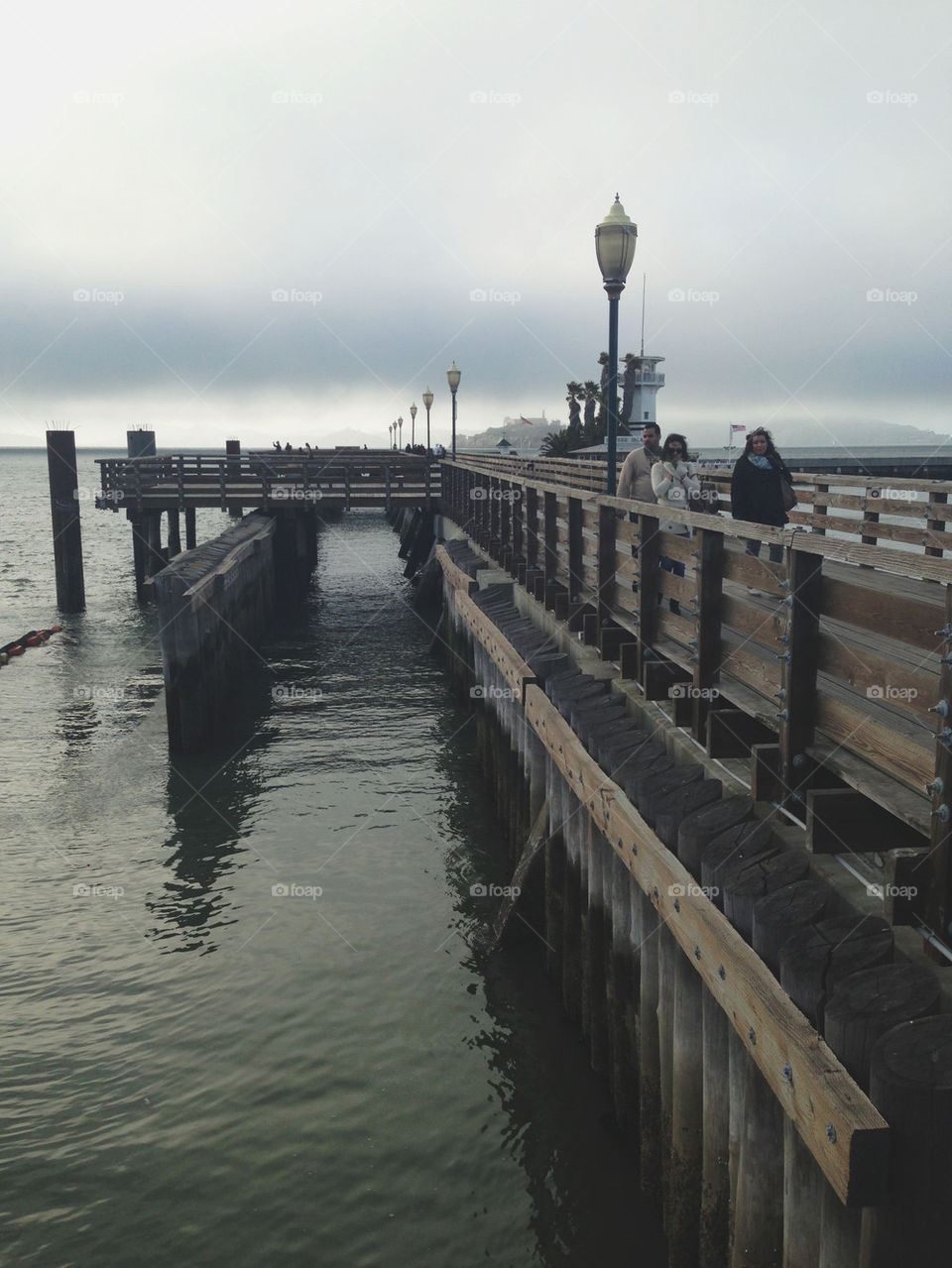 PEOPLE WALKING ON PIER