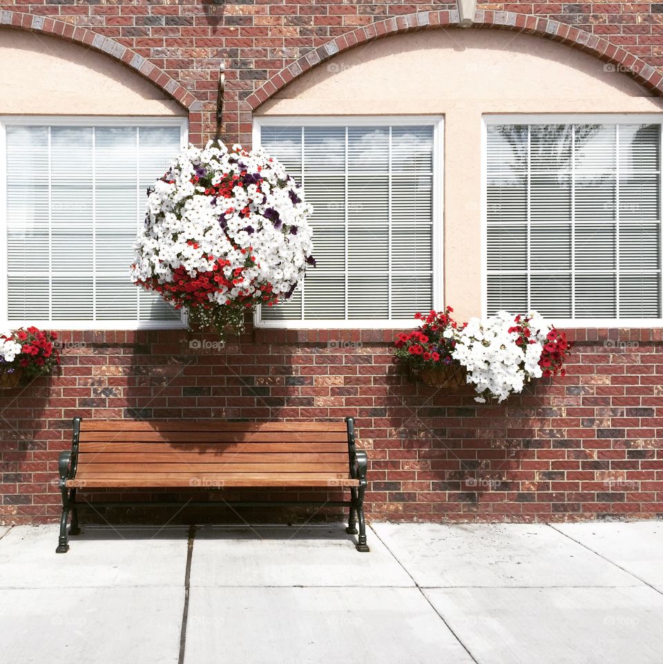 Bench on street with flowers