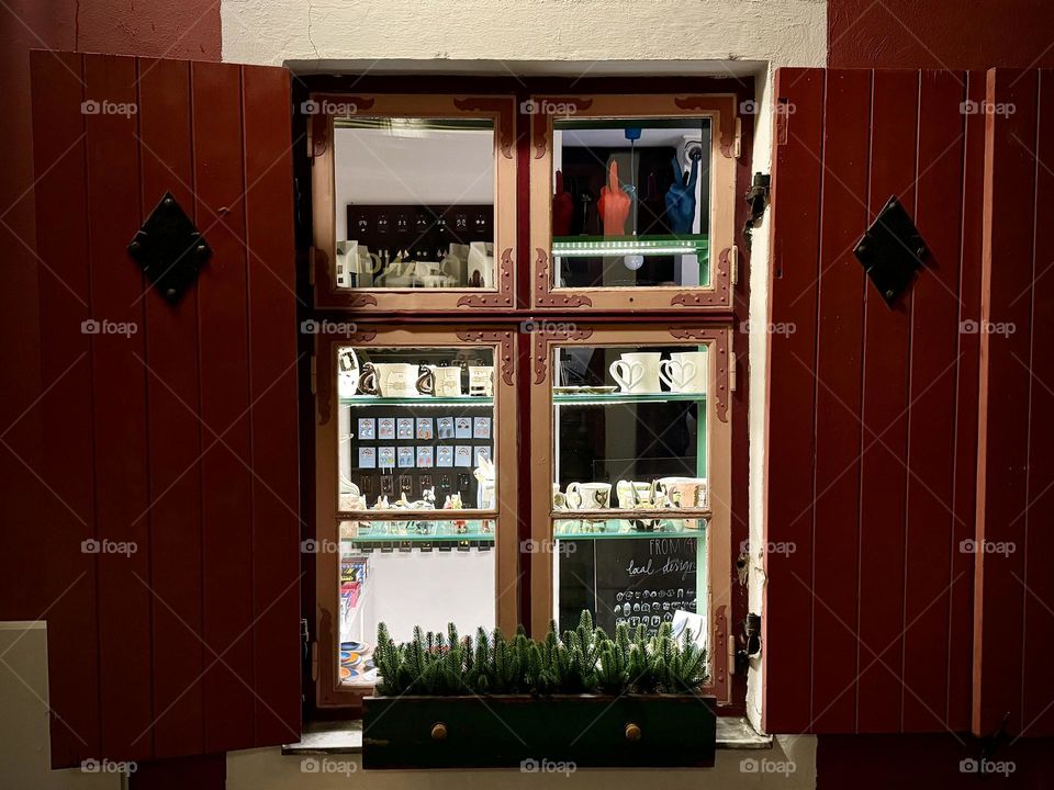 illuminated window in a gift shop with wooden shutters