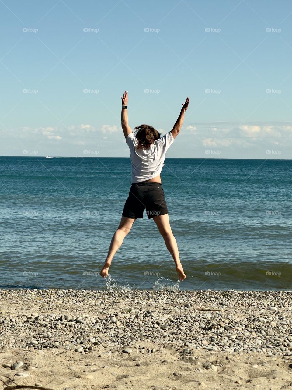 Girl jumping on the beach