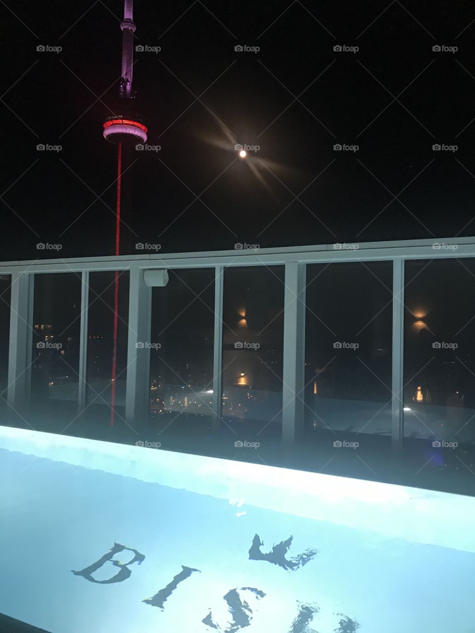 CN tower Toronto at night rooftop pool 