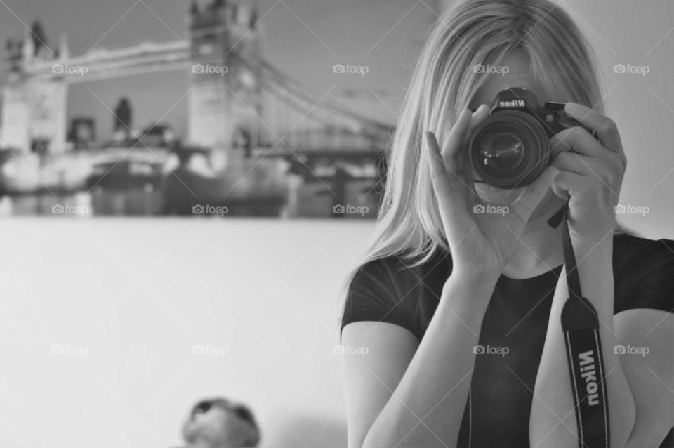 Woman taking photo with Nikon Camera b&w image
