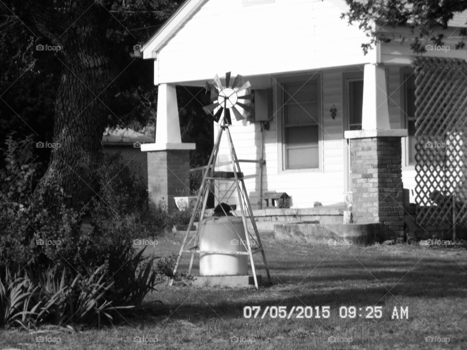 wind 💨 mill. This is a picture of a wind 💨 mill used for decoration in front of this house 🏡 in Graham Texas