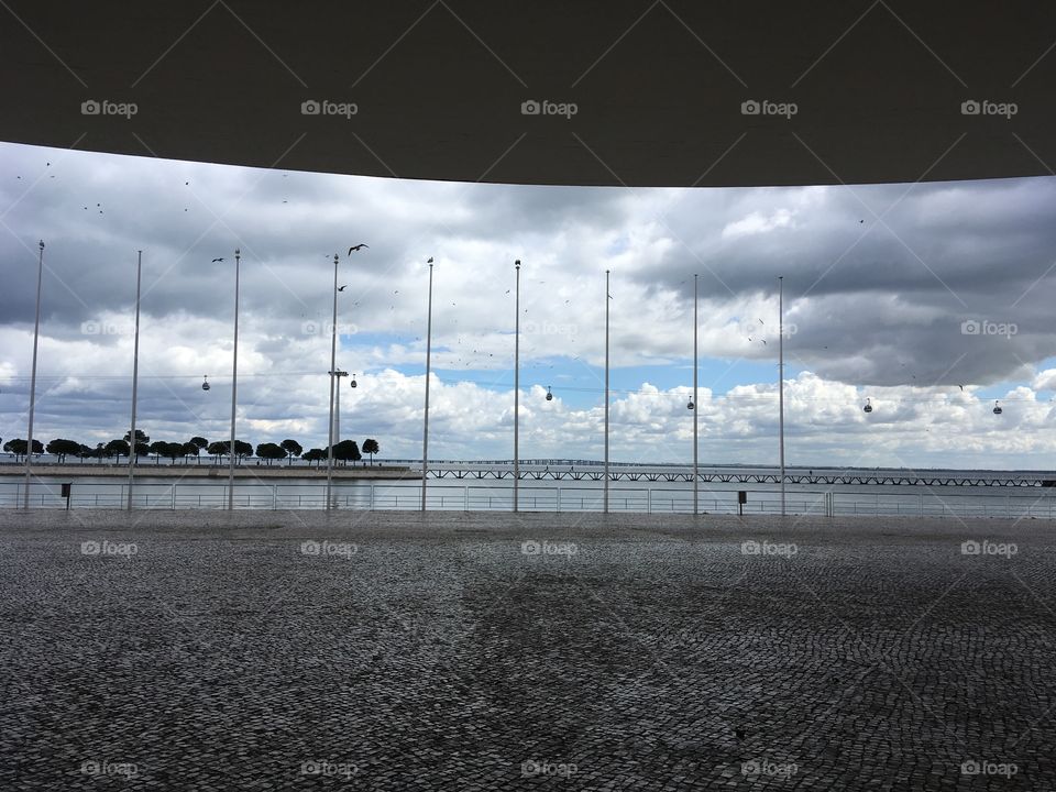 Clouds, birds, water and portuguese mosaic paving