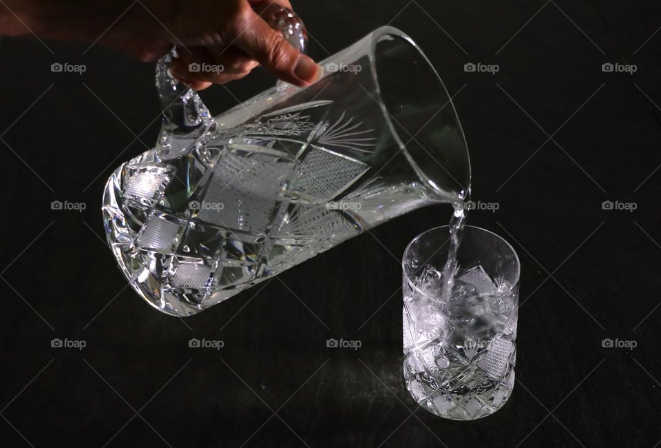 Pouring water into the crystal glass