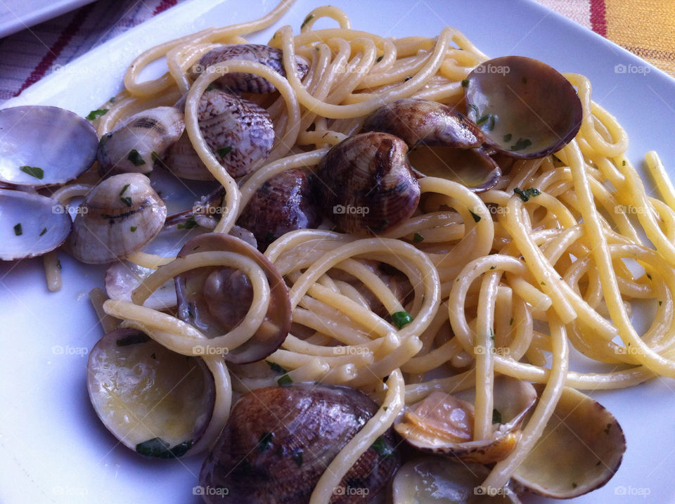 Pasta dish. Pasta with clams on a plate in Italy