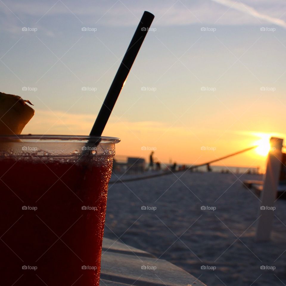 Drinks and sunsets. Having a drink on the beach is the most relaxing activity