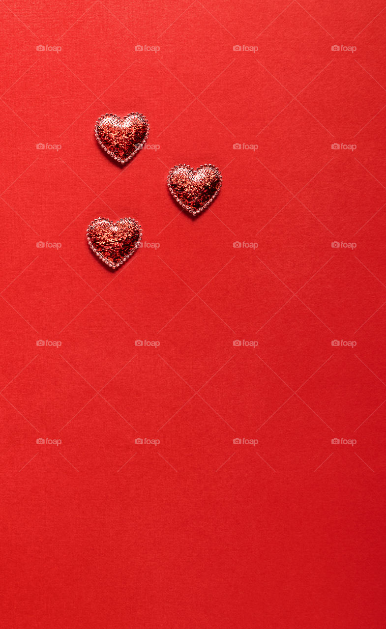 Red hearts on a red background. Valentine's Day.