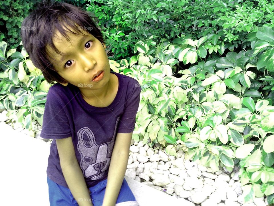 asian girl sitting by a plant box