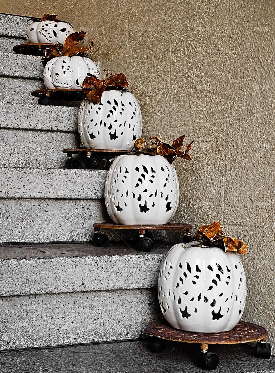 white pumpkin lanterns lining the steps to a home for the fall, Halloween,  and Thanksgiving