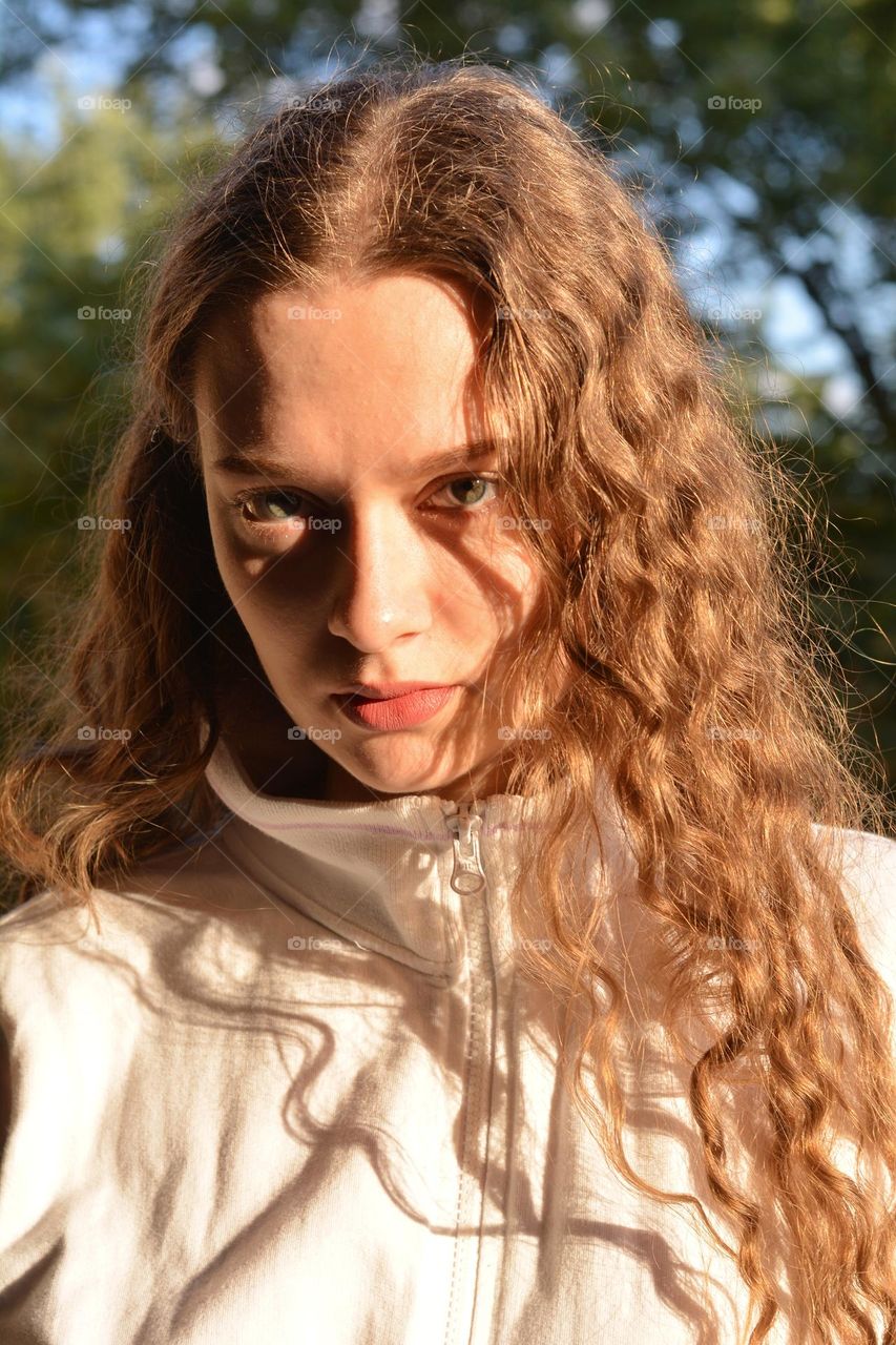 beautiful brunette girl portrait close up in sunlight and shadows