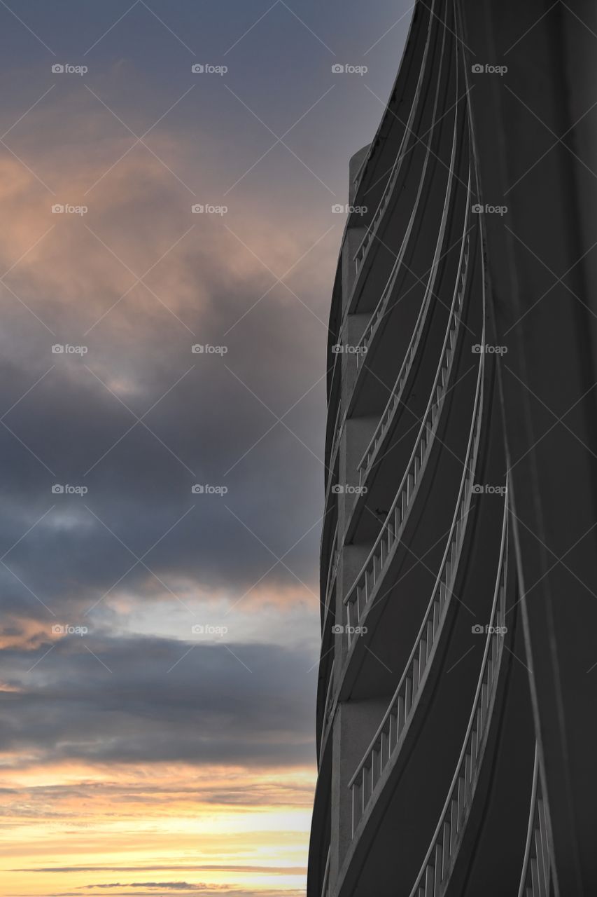 Hotel balconies in Atlantic city stretch vertically into a dramatic sunset cloudscape.