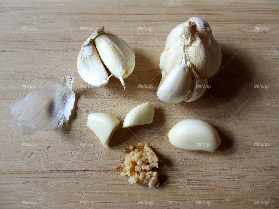 Garlic bulb and cloves on wooden