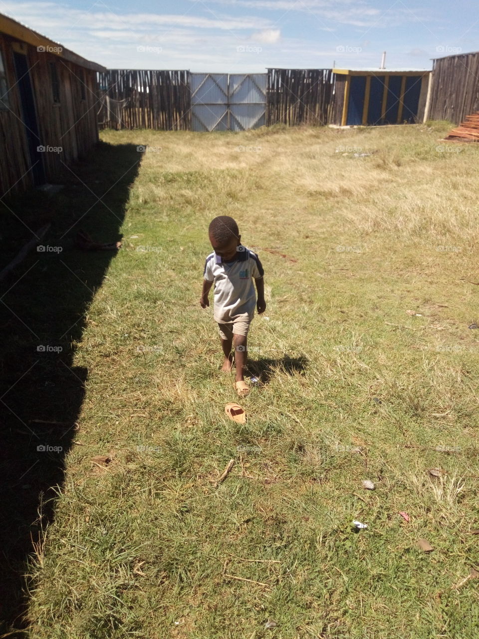 a kid walking alone inside a home compound.