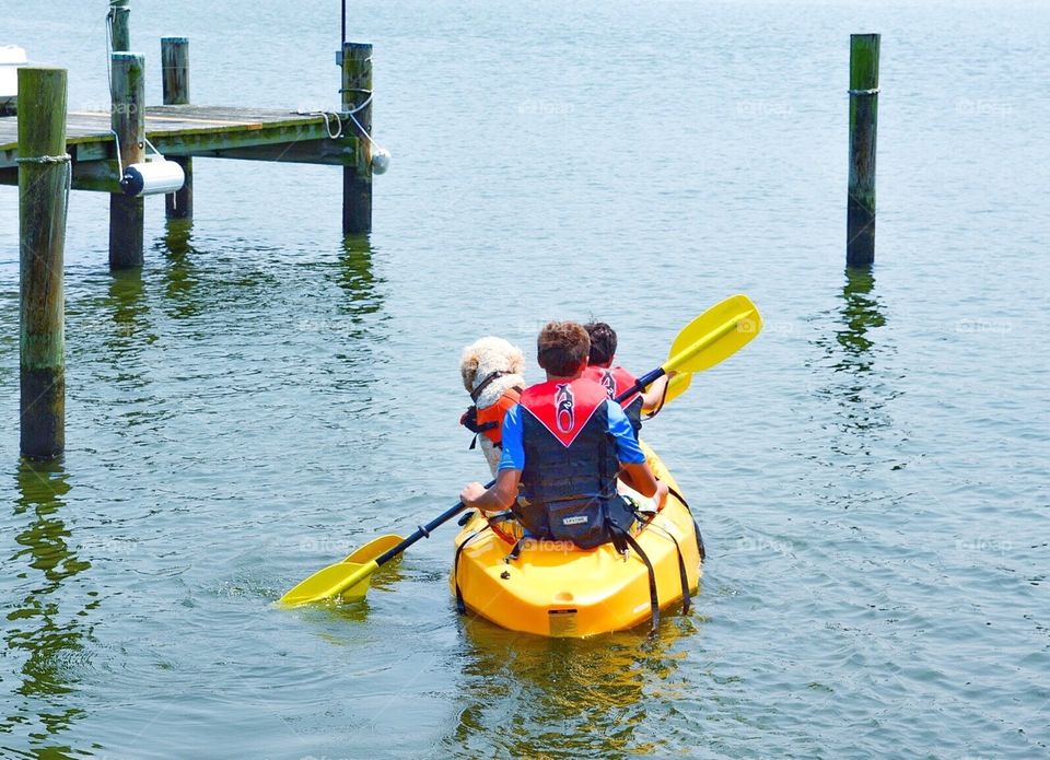 Children kayaking with dog