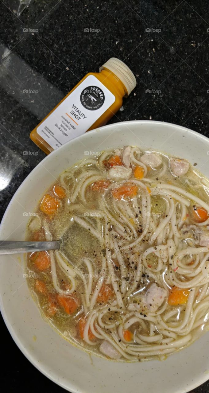 the remedy for a cold: chicken noodle soup and a wellness shot from juice press