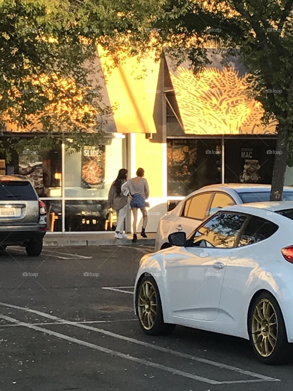 Two people walking to the store.